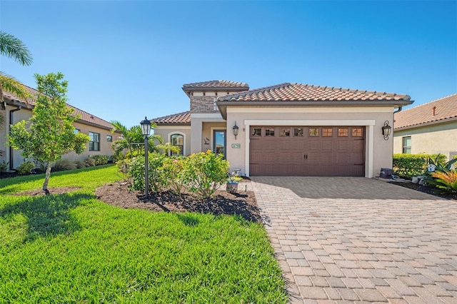 mediterranean / spanish home with a garage and a front yard