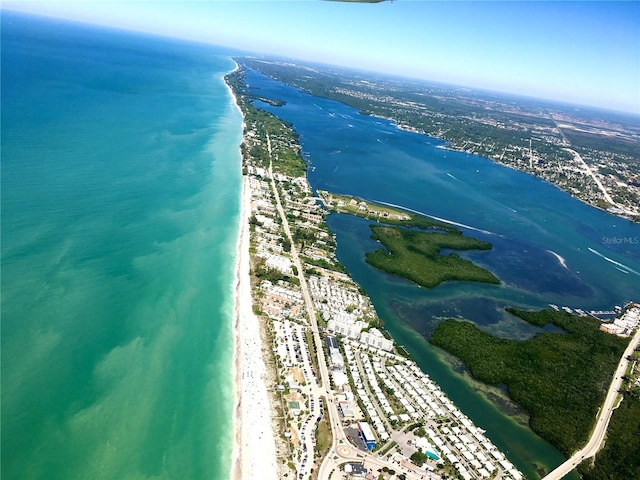 drone / aerial view with a water view and a beach view