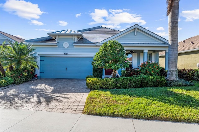 view of front of property with a garage and a front yard