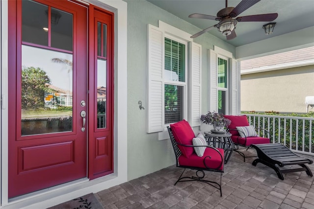 doorway to property with covered porch and ceiling fan