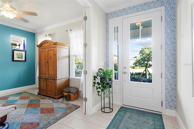 doorway to outside featuring ornamental molding, ceiling fan, and light tile patterned flooring