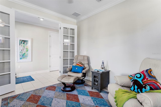 sitting room with tile patterned flooring, crown molding, and french doors