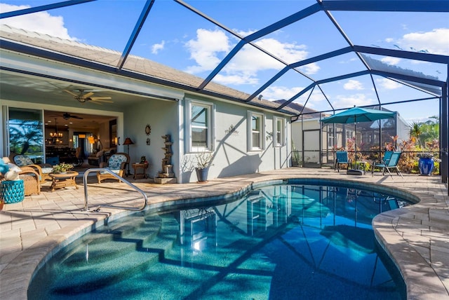 view of swimming pool featuring a patio, a lanai, and ceiling fan