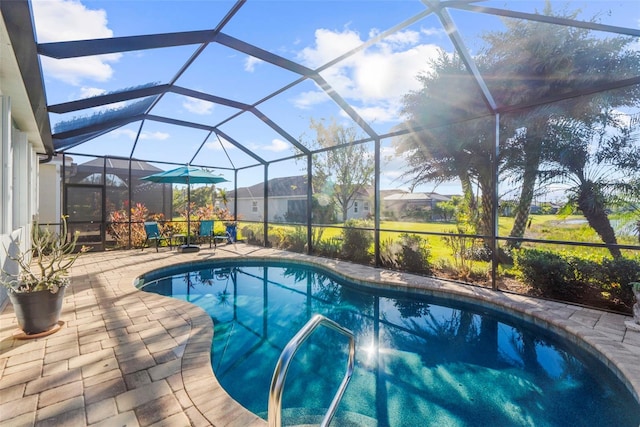 view of swimming pool featuring a patio and glass enclosure