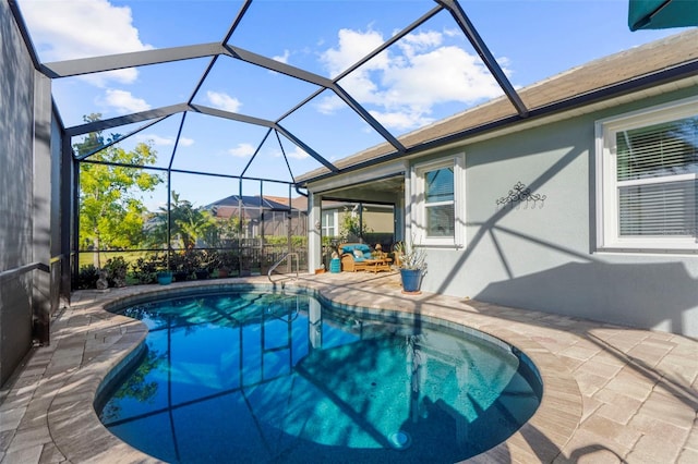 view of swimming pool featuring glass enclosure and a patio area