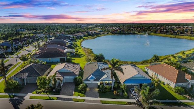 aerial view at dusk with a water view