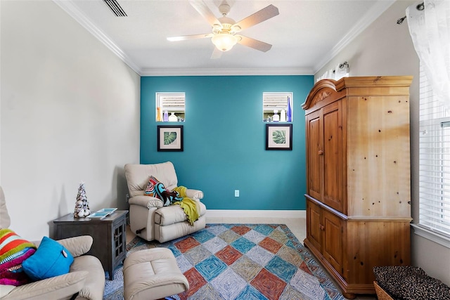 sitting room featuring ornamental molding and ceiling fan