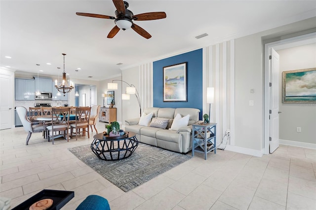 living room featuring crown molding and ceiling fan with notable chandelier