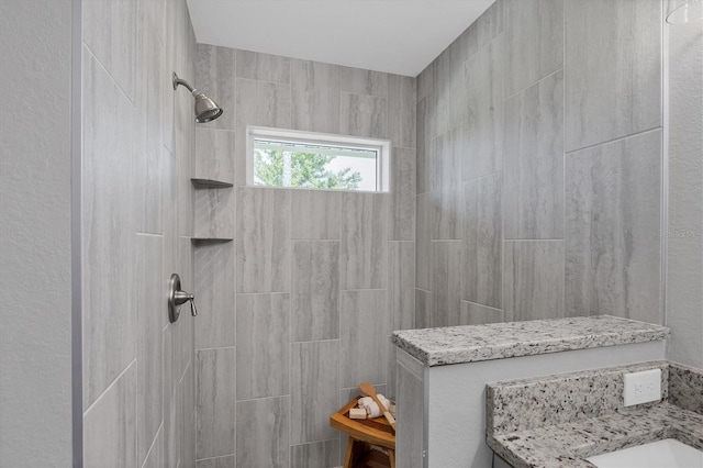 bathroom with tiled shower