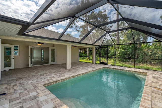 view of swimming pool featuring ceiling fan, a lanai, and a patio