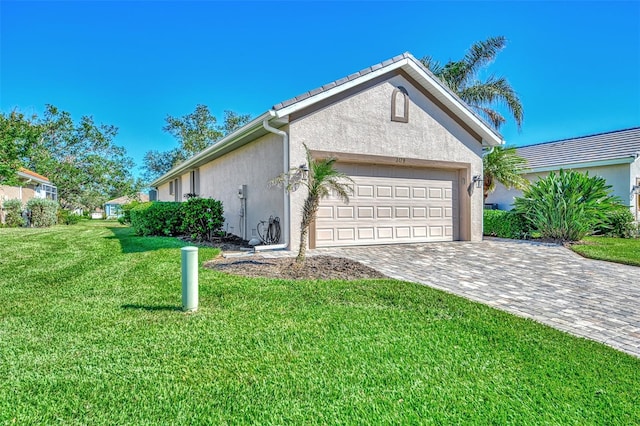 view of side of home featuring a garage and a yard