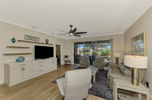 living room featuring ceiling fan, light hardwood / wood-style floors, and ornamental molding