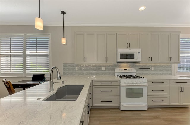 kitchen featuring light stone countertops, white appliances, sink, and light hardwood / wood-style flooring