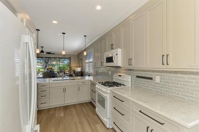 kitchen featuring ceiling fan, hanging light fixtures, kitchen peninsula, crown molding, and white appliances