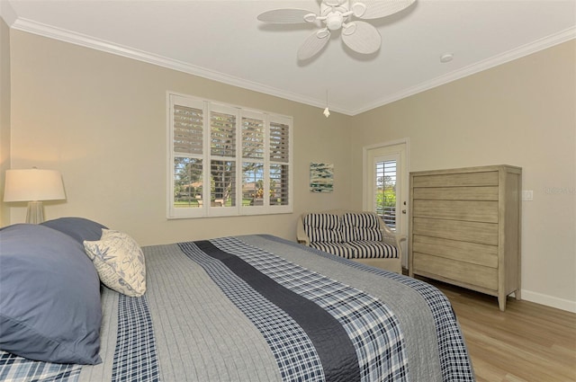 bedroom featuring ceiling fan, light hardwood / wood-style flooring, and crown molding