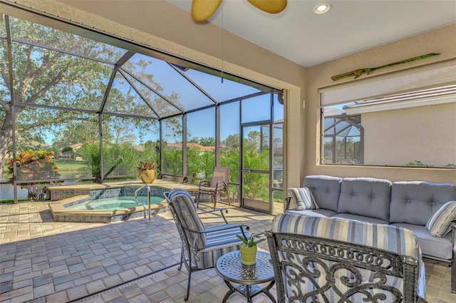 view of patio with a lanai, outdoor lounge area, and an in ground hot tub