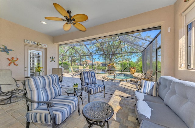 view of patio / terrace featuring a lanai, ceiling fan, and an outdoor living space