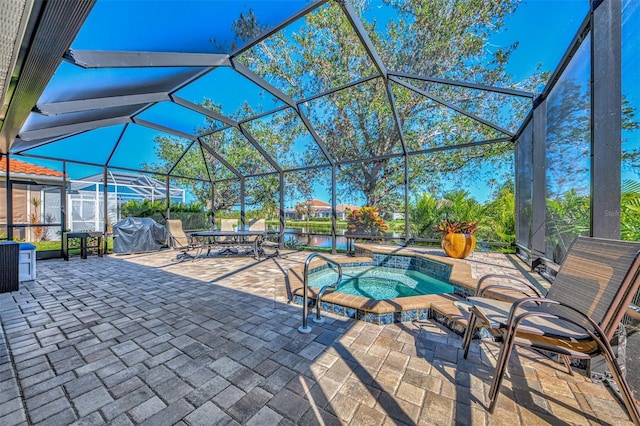 view of patio featuring a jacuzzi and glass enclosure