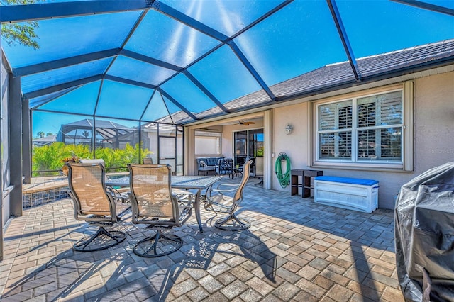 view of patio with ceiling fan and a lanai