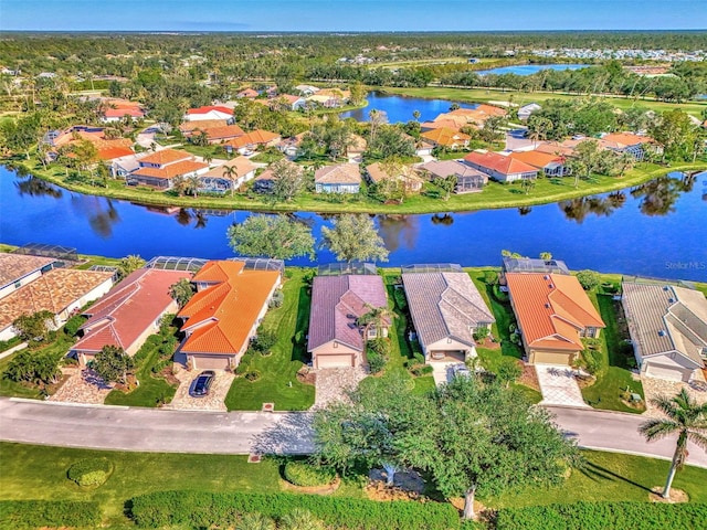 birds eye view of property with a water view