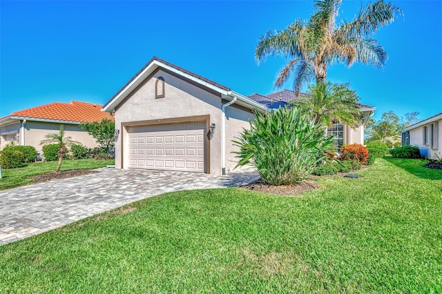 view of front of house featuring a garage and a front lawn