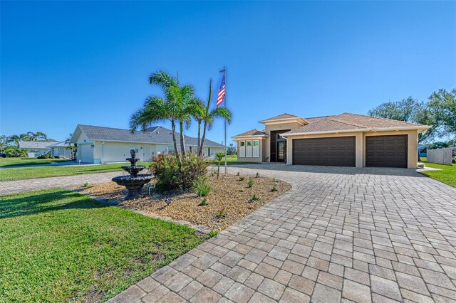 ranch-style house with a front yard and a garage