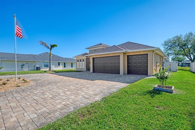 single story home featuring central AC, a front yard, and a garage