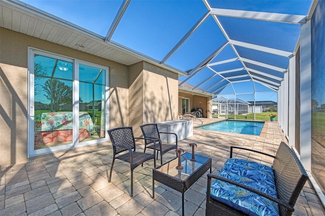 view of swimming pool featuring a patio area and a lanai