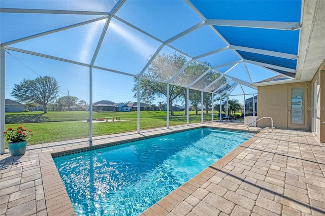 view of swimming pool featuring a patio area, a lanai, and a yard