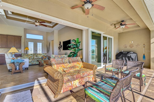 exterior space with french doors and a tray ceiling