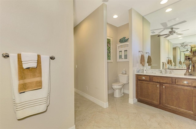 bathroom featuring vanity, toilet, and ceiling fan