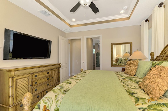 bedroom featuring a tray ceiling, ceiling fan, and crown molding