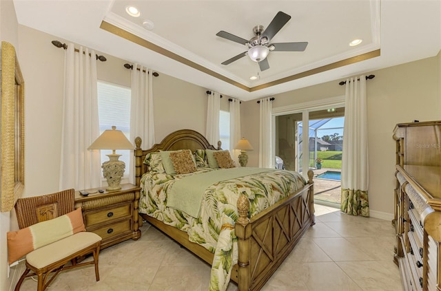 bedroom featuring ceiling fan, access to exterior, crown molding, and a tray ceiling