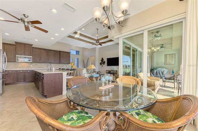 dining room with light tile patterned floors, sink, and a chandelier