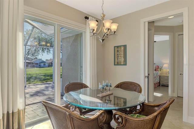 dining room with light tile patterned floors and a notable chandelier