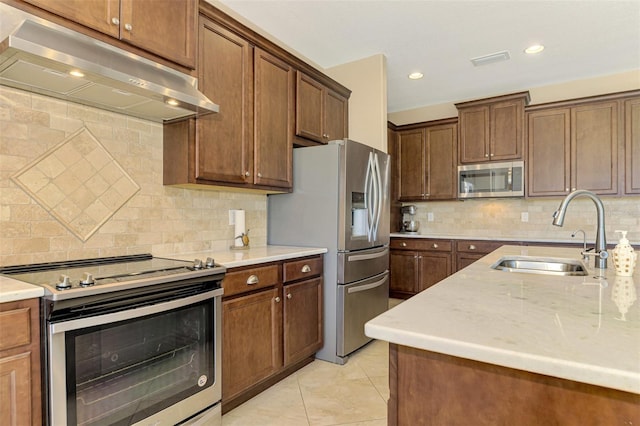 kitchen featuring sink, light tile patterned floors, stainless steel appliances, and tasteful backsplash