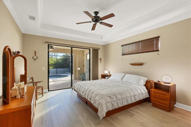 2 Marker Rd, Rotonda West, FL 33947 - bedroom with a raised ceiling, access to exterior, ornamental molding, light wood-style flooring, and baseboards