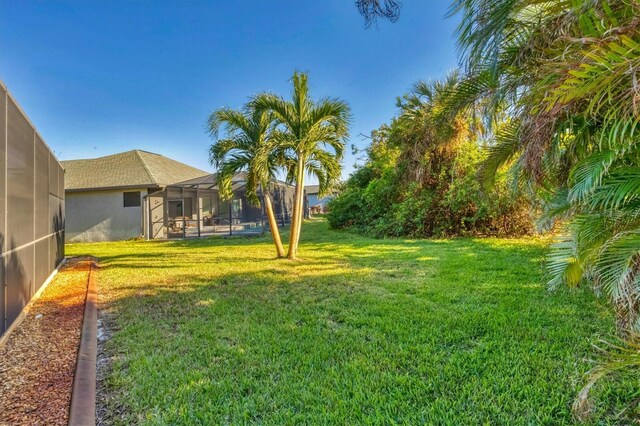 2 Marker Rd, Rotonda West, FL 33947 - view of green lawn with glass enclosure