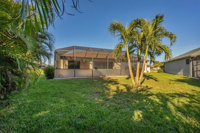 2 Marker Rd, Rotonda West, FL 33947 - view of green lawn featuring glass enclosure