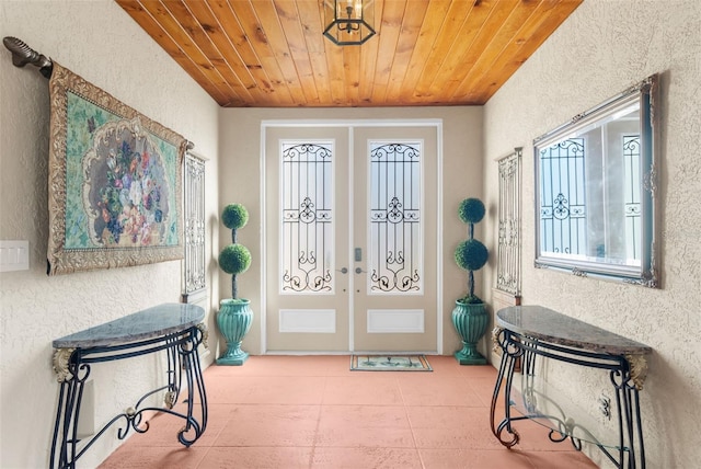 foyer entrance featuring french doors and wood ceiling