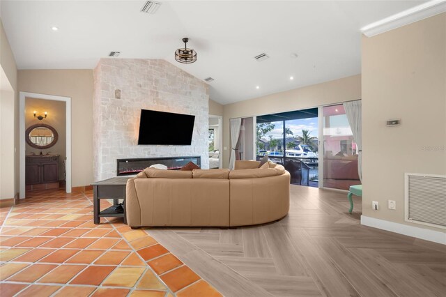 living room with parquet flooring, a fireplace, and lofted ceiling