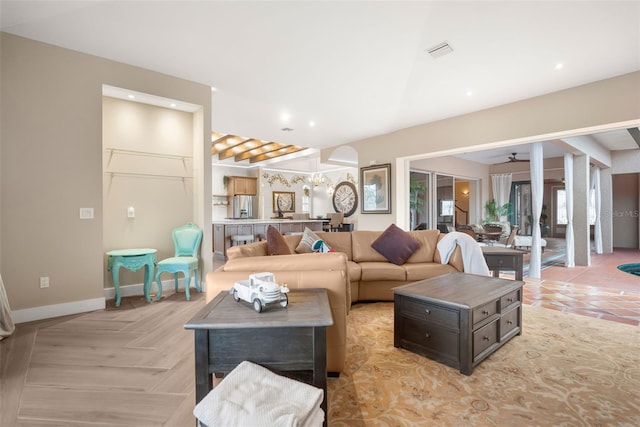 tiled living room with beam ceiling and ceiling fan