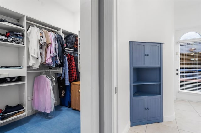 spacious closet featuring light tile patterned floors