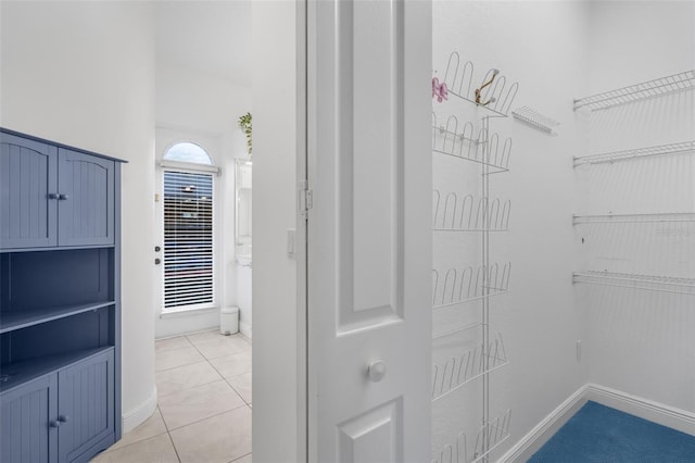 spacious closet with light tile patterned floors