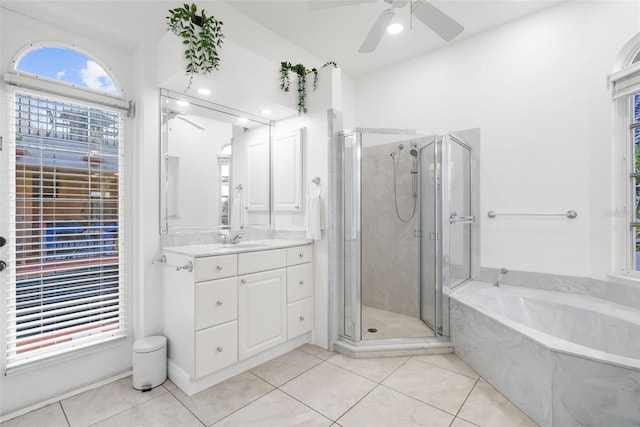 bathroom with ceiling fan, tile patterned flooring, vanity, and plus walk in shower