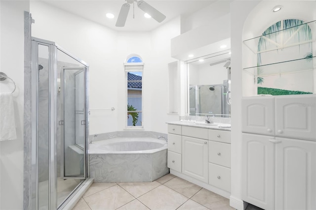 bathroom featuring tile patterned flooring, vanity, ceiling fan, and plus walk in shower