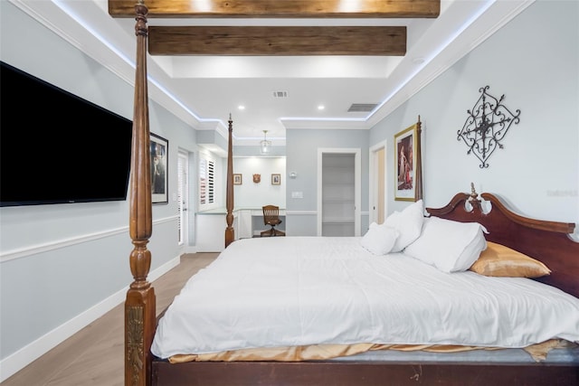 bedroom featuring beamed ceiling, light wood-type flooring, and ornamental molding