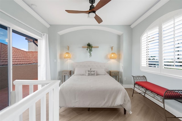 bedroom with multiple windows, ceiling fan, crown molding, and light hardwood / wood-style floors