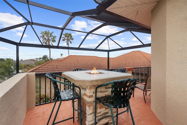 view of patio featuring a lanai and an outdoor fire pit