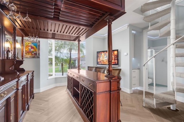 bar with crown molding and light parquet flooring